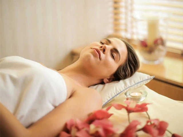 Lady in Enveloped by White Towel Lying on Bed with Eyes Shut