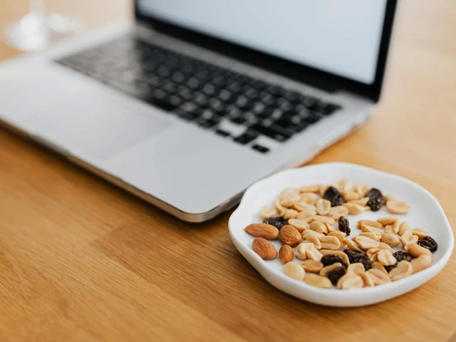 Nuts and Raisins for Healthy Snack by Laptop 