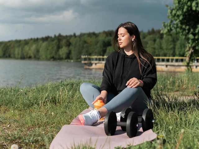 A Woman Sitting on a Pink Yoga Mat Near the Lake 